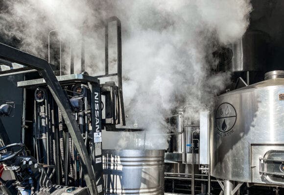 Interior of a brewery with a fork lift and smoke