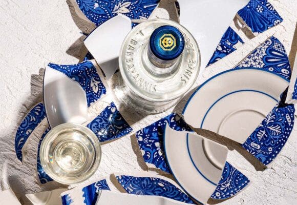 Bottles of Ouzo with broken plates