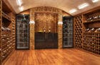 Image of wood floor wine cellar with many bottles on display